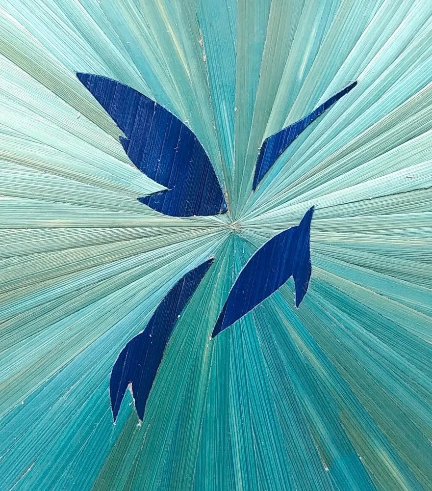 Zoom sur la décoration d'un boîte à thé ou coffret à chocolats avec un colibri bleu nuit au cœur d'un soleil bleu ciel