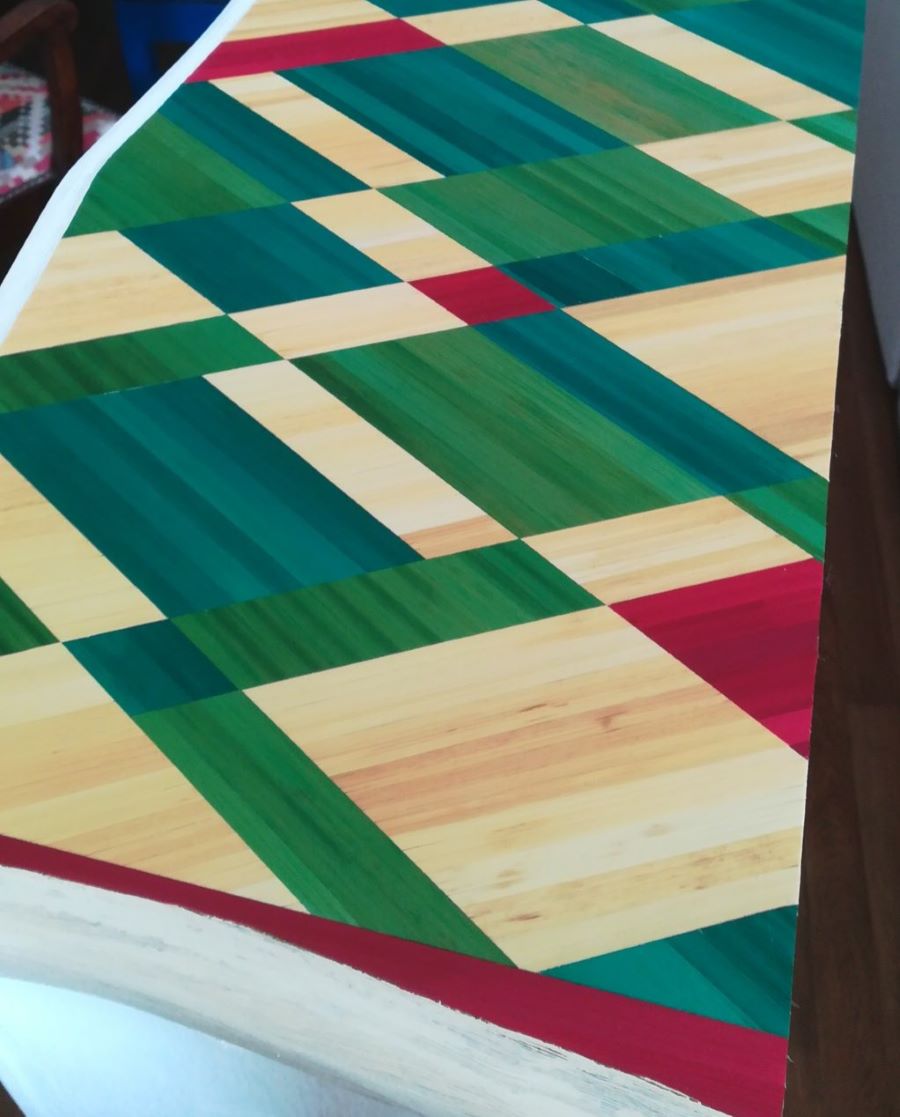 La bibliothèque est peinte en blanc et certaines étagères sont en bois brut, donnant un air naturel à l’ensemble.